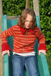 Portrait of cute girl sliding at park