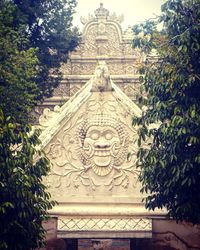 Statue of temple against building