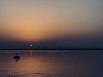 Scenic view of sea against sky at sunset