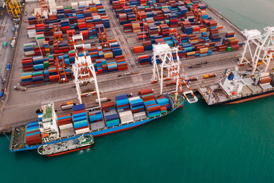 Containers ship and shipping ports cargo logistic freight load unloading by crane forwarding 