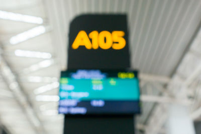 Close-up of yellow sign on airport