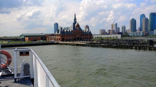 Arch bridge over river against buildings in city