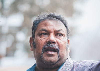 Close-up of mature man looking away