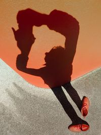 Low section of man shadow on hand