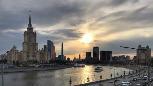 View of buildings against cloudy sky during sunset