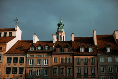 Low angle view of buildings in town against sky