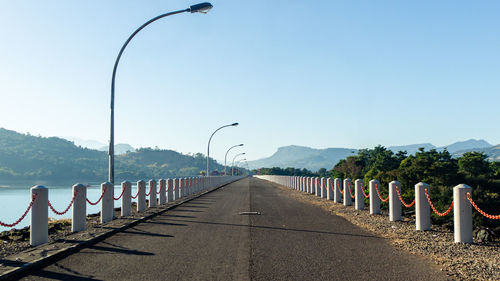 Street light by road against clear sky