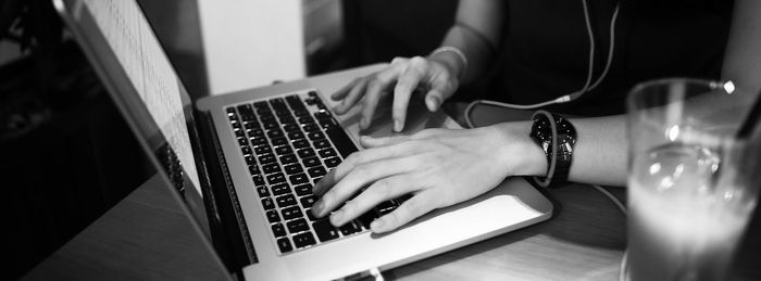 Cropped image of hand working on table