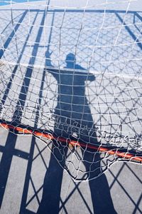 Shadow of man on soccer goal post