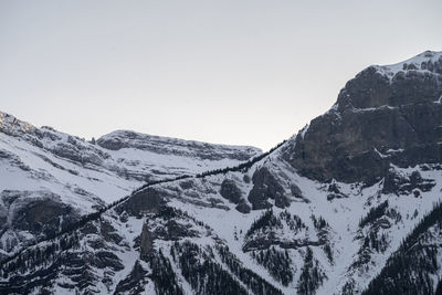 Scenic view of snowcapped mountains against clear sky