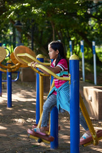 Full length of girl playing with equipment at park