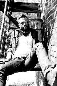 Portrait of young man sitting outdoors