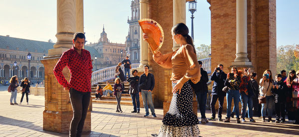 Group of people in front of buildings