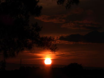 Scenic view of silhouette trees against romantic sky at sunset