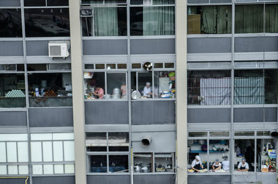 People standing at office building in city