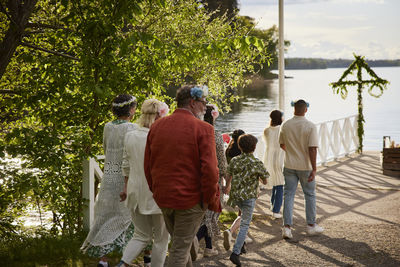 Family walking on jetty by lake