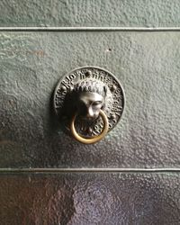 Close-up of metallic lion door knocker