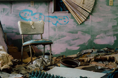 Close-up of abandoned chair in messy area