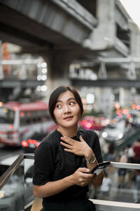 Portrait of young woman standing outdoors