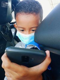 Portrait of boy using mobile phone