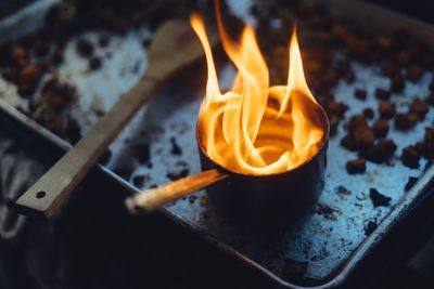 High angle view of burning container in tray