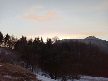 Scenic view of snowcapped mountains against sky during sunset