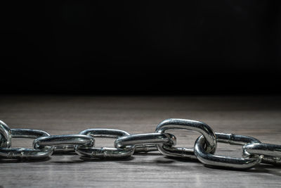 Close-up of chain against black background