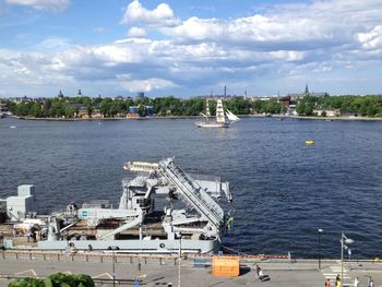 Boats in harbor with city in background