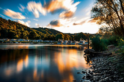 Scenic view of lake against sky at sunset