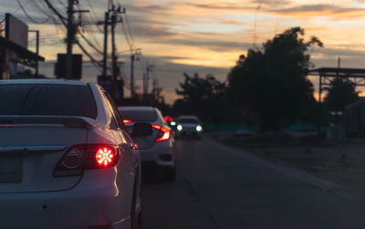 Cars on road at sunset