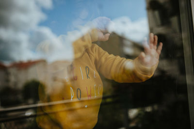 Reflection of child on trough window