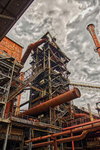 Low angle view of crane against sky