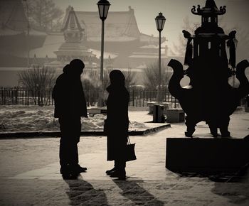 Rear view of people walking on street