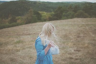 Side view of woman walking on landscape