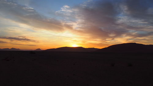 Scenic view of silhouette landscape against sky during sunset