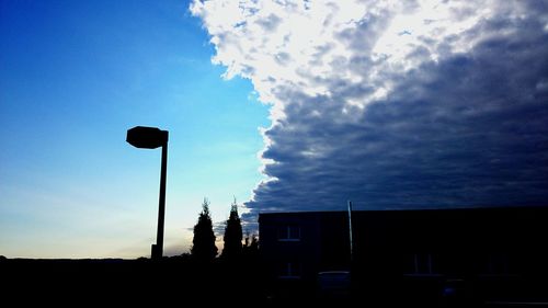 Low angle view of silhouette buildings against sky