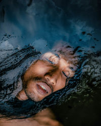 High angle view of man with eyes closed in water