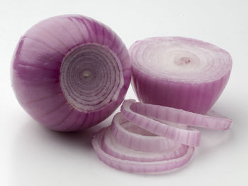 Close-up of onions over white background