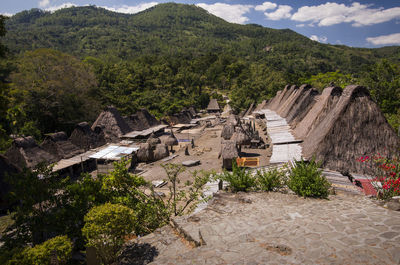 High angle view of houses on mountain against cloudy sky