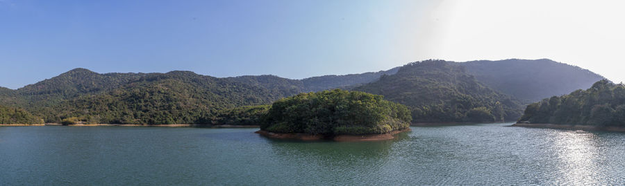 Scenic view of river and mountains against clear sky