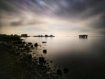 Scenic view of sea against sky at sunset