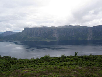 Scenic view of lake and mountains against sky