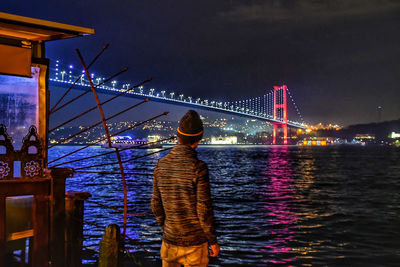 Rear view of golden gate bridge over river at night