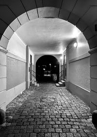 Empty footpath in illuminated tunnel