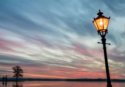 Low angle view of street light against sky during sunset