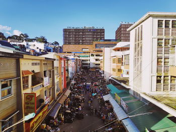 High angle view of people on street amidst buildings in city