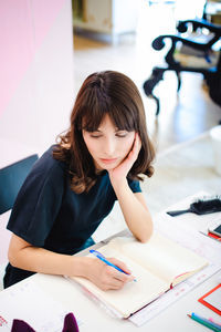 Young businesswoman working at desk in home office