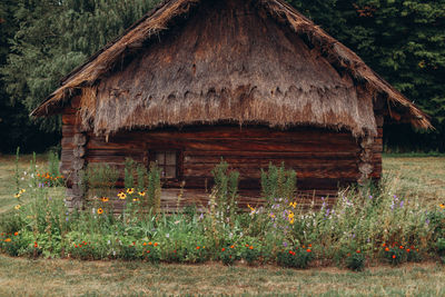 Old wooden house on field