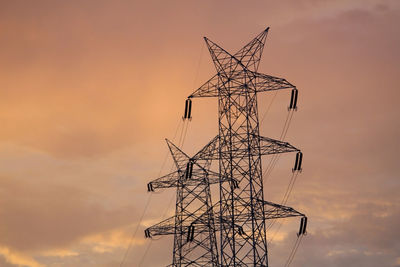 Energy powers of electricity towers during in evening sun set time.