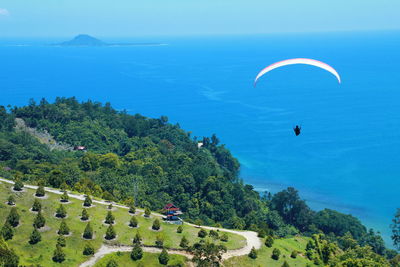 High angle view of sea and trees against sky